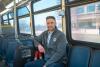 A person sitting on a bus.